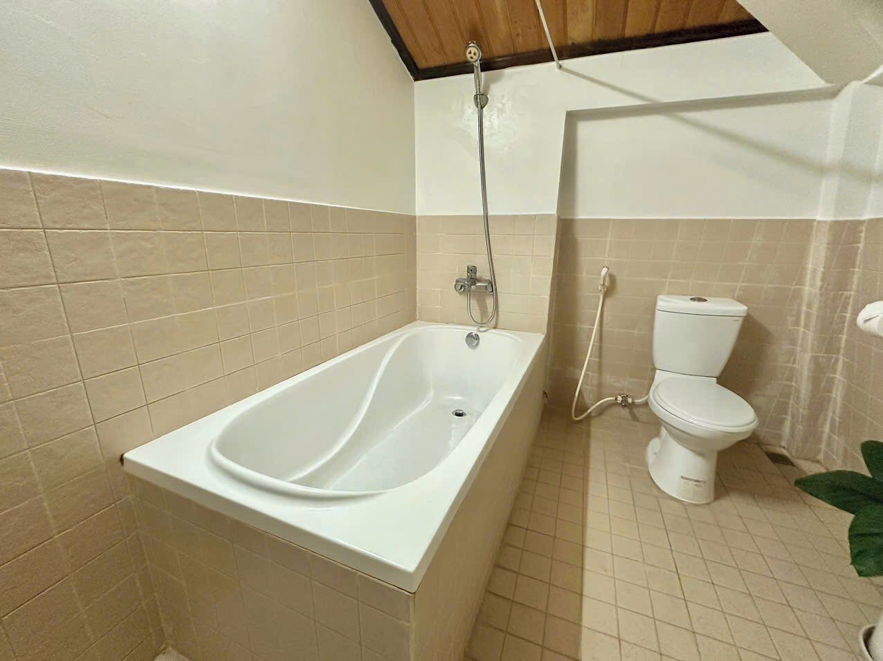 A bathroom with a bathtub, toilet, and shower.