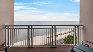 A balcony with a view of the beach and a road. - Legacy Tower II- #1406 - 2BR/2BA Penthouse Gulf-View Condo - Resort Pools + Spa (Gulfport)