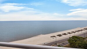 A coastal road with a beach and ocean in the background. - Legacy Tower II- #1406 - 2BR/2BA Penthouse Gulf-View Condo - Resort Pools + Spa (Gulfport)