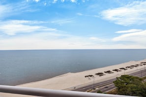 A coastal road with a beach and ocean in the background.