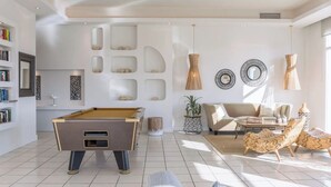 A modern living room with a pool table, a sofa, and a coffee table. - Marilena Sea View (Pirgi)