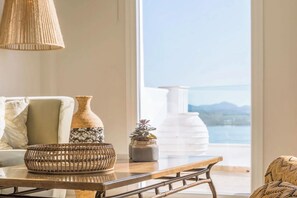 A room with a view of the sea, a wicker basket, a vase, and a table. - Marilena Sea View (Pirgi)