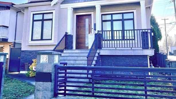 A two-story house with a front porch, a wooden door, and a staircase leading to the entrance.