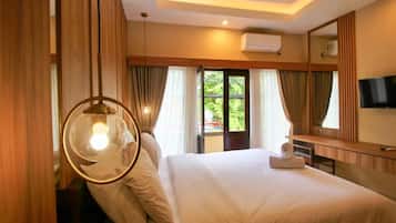 Une chambre d’hôtel avec un lit, un bureau, un miroir et une télévision.