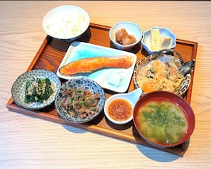 A wooden tray with various dishes including a bowl of soup, a plate of fish, and several small bowls with different foods. - APA Hotel Keisei Ueno Ekimae Minami (Tokyo)
