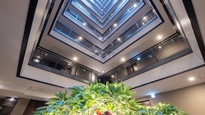 A modern atrium with a central garden and skylights. - APA Hotel Keisei Ueno Ekimae Minami (Tokyo)