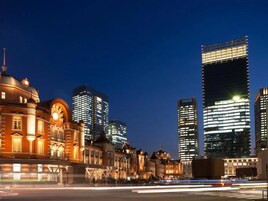 A cityscape at night with historic buildings and modern skyscrapers.