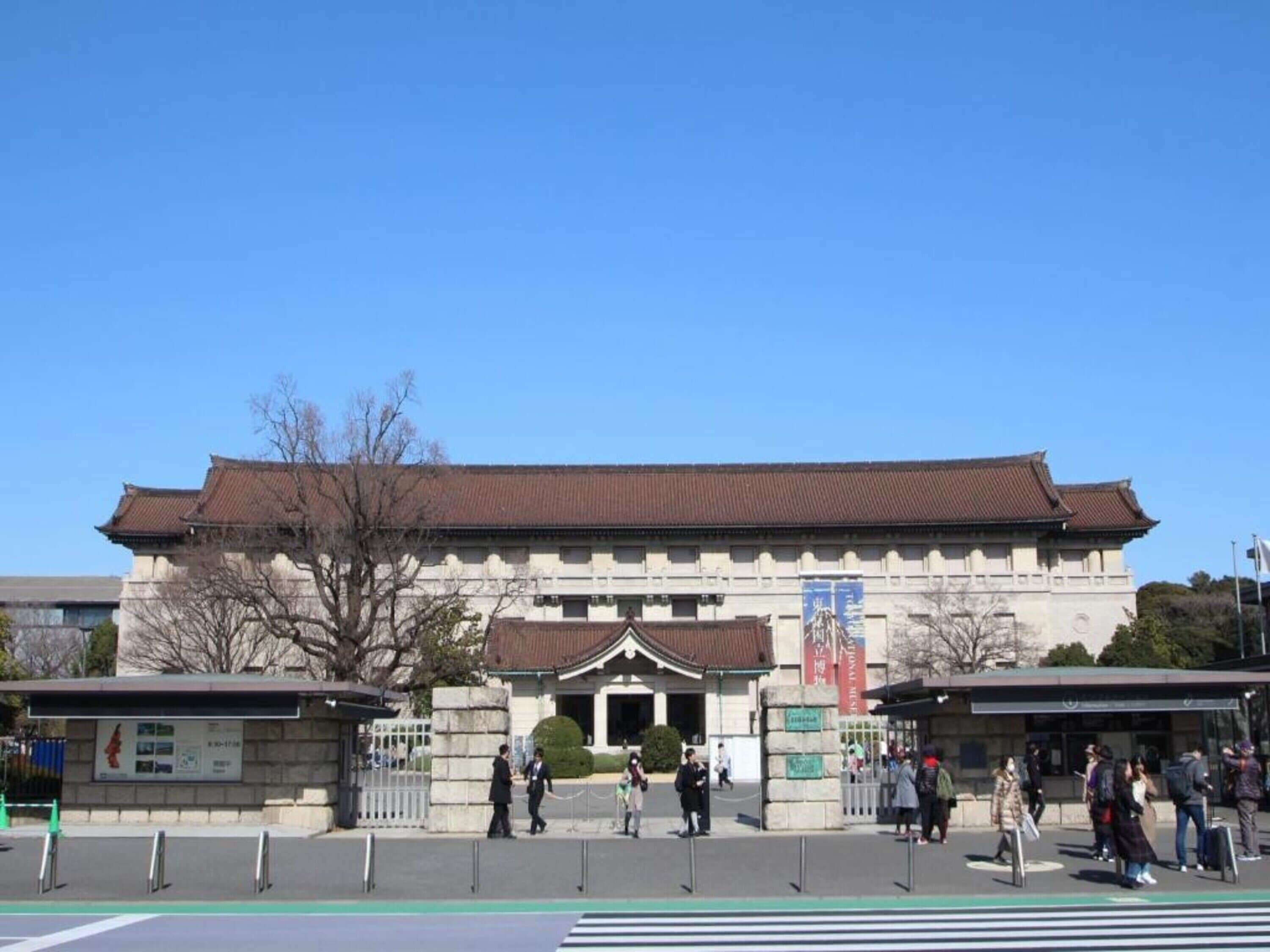 A traditional building with a tiled roof and a central entrance.