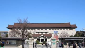 A traditional building with a tiled roof and a central entrance.