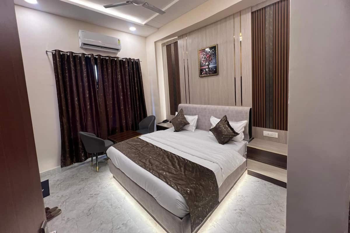 A modern bedroom with a bed, a desk, and a chair.