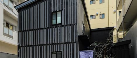 A modern building with a flat roof and a vertical facade.