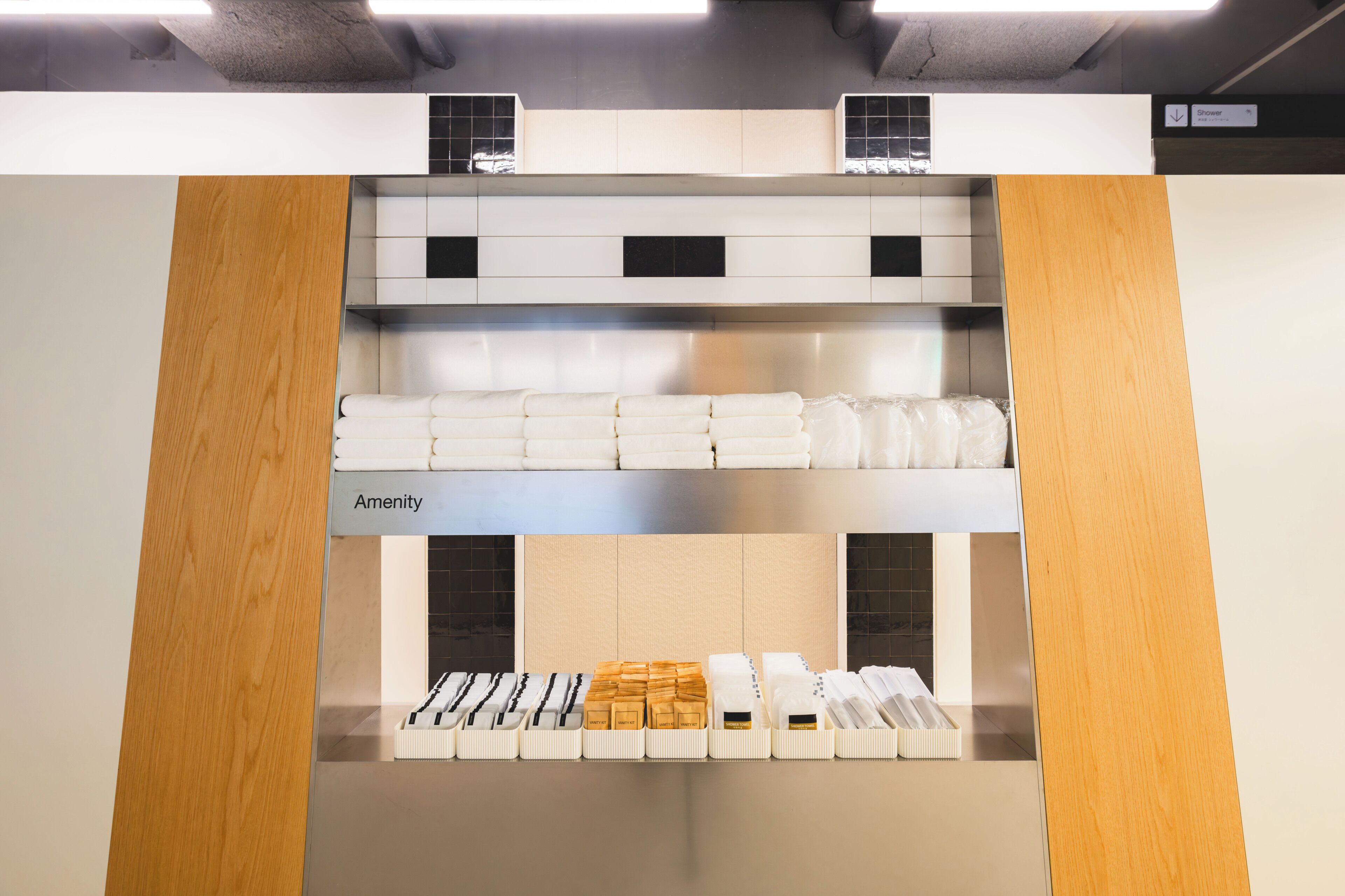 A hotel room with a kitchenette, a bathroom with a shower, and a storage area labeled 'Amenity.'