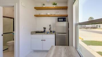 Fridge, microwave, coffee/tea maker, cookware/dishes/utensils