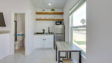 Fridge, microwave, coffee/tea maker, cookware/dishes/utensils