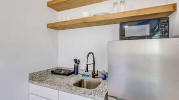 Fridge, microwave, coffee/tea maker, cookware/dishes/utensils