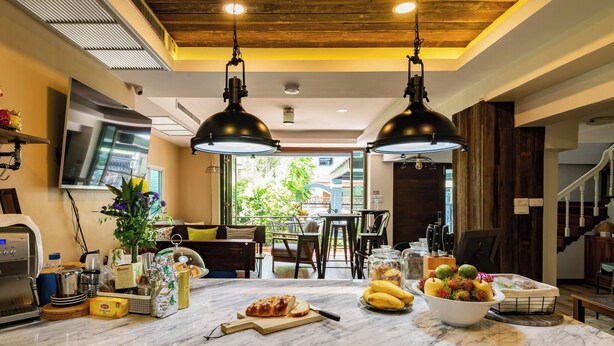 A kitchen with a marble countertop, two pendant lights, a large window, and a view of the outdoors. - Luxurious retreat with premium amenities & comfort (Bangkok)