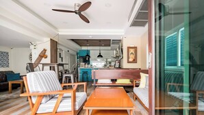 A modern living room with a sofa, chairs, a coffee table, and a ceiling fan. - Take Time Out on the Serene Balcony in the City (Bangkok)
