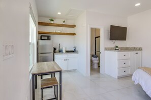 A modern kitchen with white cabinets, a built-in microwave, and a wooden countertop. - Beach, Bars & Bites Nearby! Prime South Padre Unit (South Padre Island)