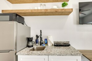 A kitchen with a microwave, coffee maker, sink, and stove. - 3 Blocks to Beach! Pet-Friendly South Padre Studio (South Padre Island)