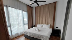 Habitación de hotel moderna con una cama grande, ventilador de techo y vista de la ciudad a través de amplias ventanas.