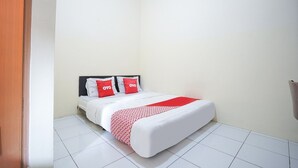 A small, clean room with a bed, white walls, and a tiled floor. - Luxury Deluxe DBL Retreat W/ Free WiFi and Parking (Yogyakarta)