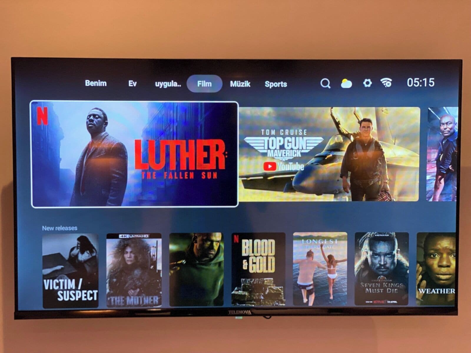 A television screen displaying a streaming service interface with movie options.