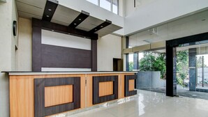 A reception desk with a modern design, a tiled floor, and a view of the outdoors. - Luxury Deluxe DBL Retreat W/ Free WiFi and Parking (Pekanbaru)