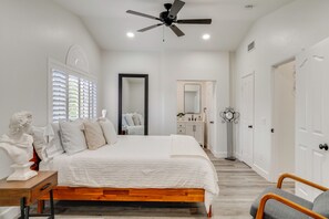 A bedroom with a bed, bedside table, and a ceiling fan. - Spacious Patio + Modern Interior: Corona Escape! (Corona)