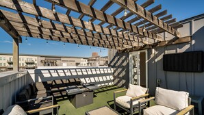 A rooftop patio with outdoor seating, a pergola, and a city view. - Work & Play! Gem w/ Fire Pit, 3 Mi to Dtwn Dallas (Dallas)