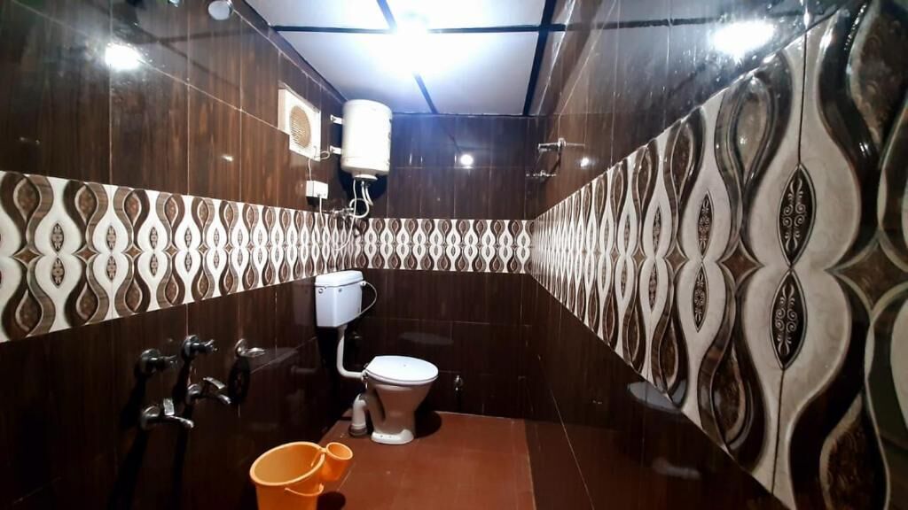 A bathroom with a toilet, a bidet, and a shower area.