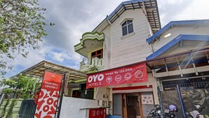 Un hôtel avec une enseigne indiquant un prix de 125 000 roupies par nuit.