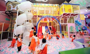 A children's play area with slides, climbing structures, and a ball pit.