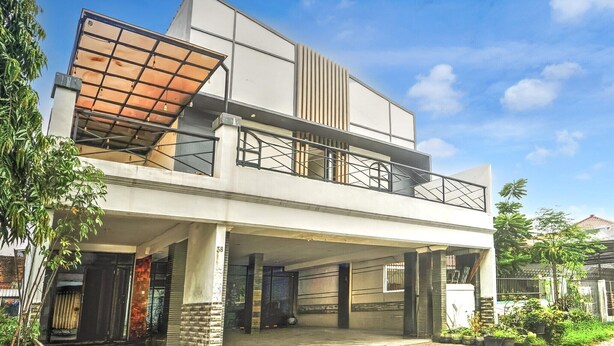 A modern two-story building with a flat roof, large windows, and a covered entrance. - Luxury Deluxe DBL Retreat W/ Free WiFi and Parking (Surabaya)