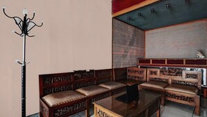 A traditional room with a wooden sofa set, a glass coffee table, and a decorative floor lamp. - Luxury Deluxe DBL Retreat W/ Free WiFi and Parking (Surabaya)