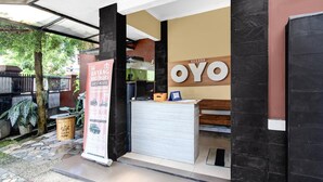 A reception desk with a sign reading 'BAYANO BROTHERS GUESTHOUSE' and a large 'OYO' logo. - Cozy Double Escape W/ Free WiFi and Parking (Yogyakarta)