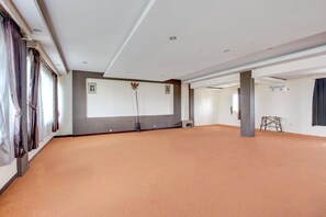 A spacious room with a large screen, a projector, and a wooden ladder. - Luxury Twin Stay with Free WiFi and Parking (Solo)