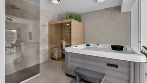 A modern bathroom with a hot tub, a glass shower enclosure, and a wooden cabinet. - Apartment Luxury Wellness (Makarska)