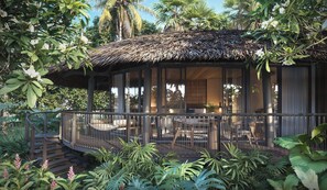 A thatched-roof structure with a covered outdoor seating area, surrounded by lush tropical vegetation. - Twinpalms Treehouses Phuket (Phuket)