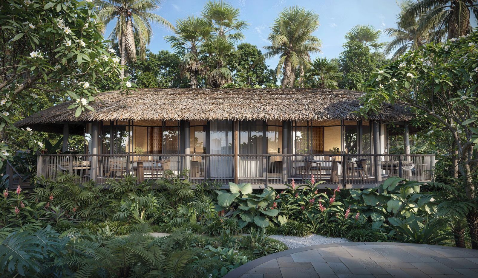 A thatched-roof structure with outdoor seating, surrounded by lush tropical vegetation.
