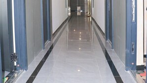 A hallway with doors on both sides, a tiled floor, and recessed lighting. - Luxury Apartments with Amazing Nairobi Park Views (Nairobi)