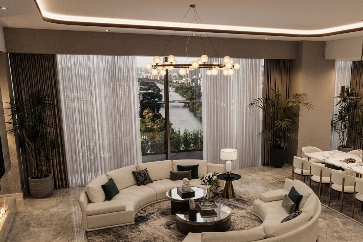 A modern living room with a curved sofa, a round coffee table, a dining table with chairs, and a fireplace.