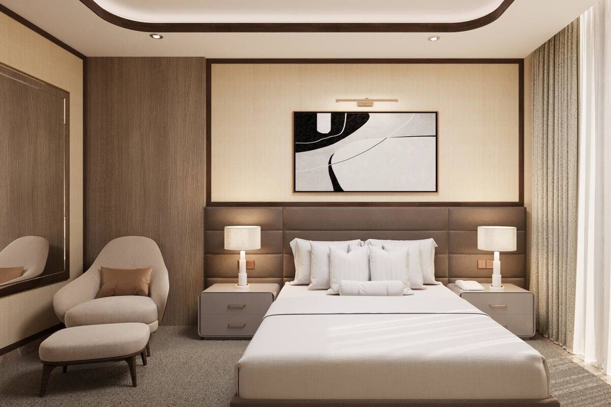 A modern hotel room with a large bed, two bedside tables, a chair, and a large abstract painting on the wall.