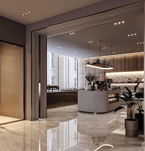 A modern kitchen with a central island, pendant lighting, and a view of the city.