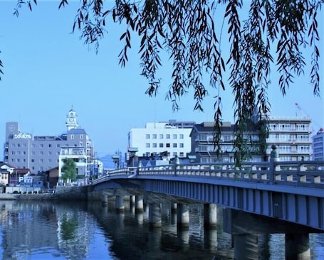 A bridge over water with buildings in the background.