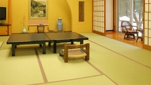A traditional Japanese room with tatami flooring, a low table, a bench, and sliding doors. - Hirayu Onsen KKR Hirayu Takaraso (Takayama)