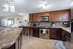 Private kitchen - Relax in this ground-floor 2BR condo in New Smyrna Beach with a private patio, lush lawn, and direct pool and beach access just steps away. (New Smyrna Beach)