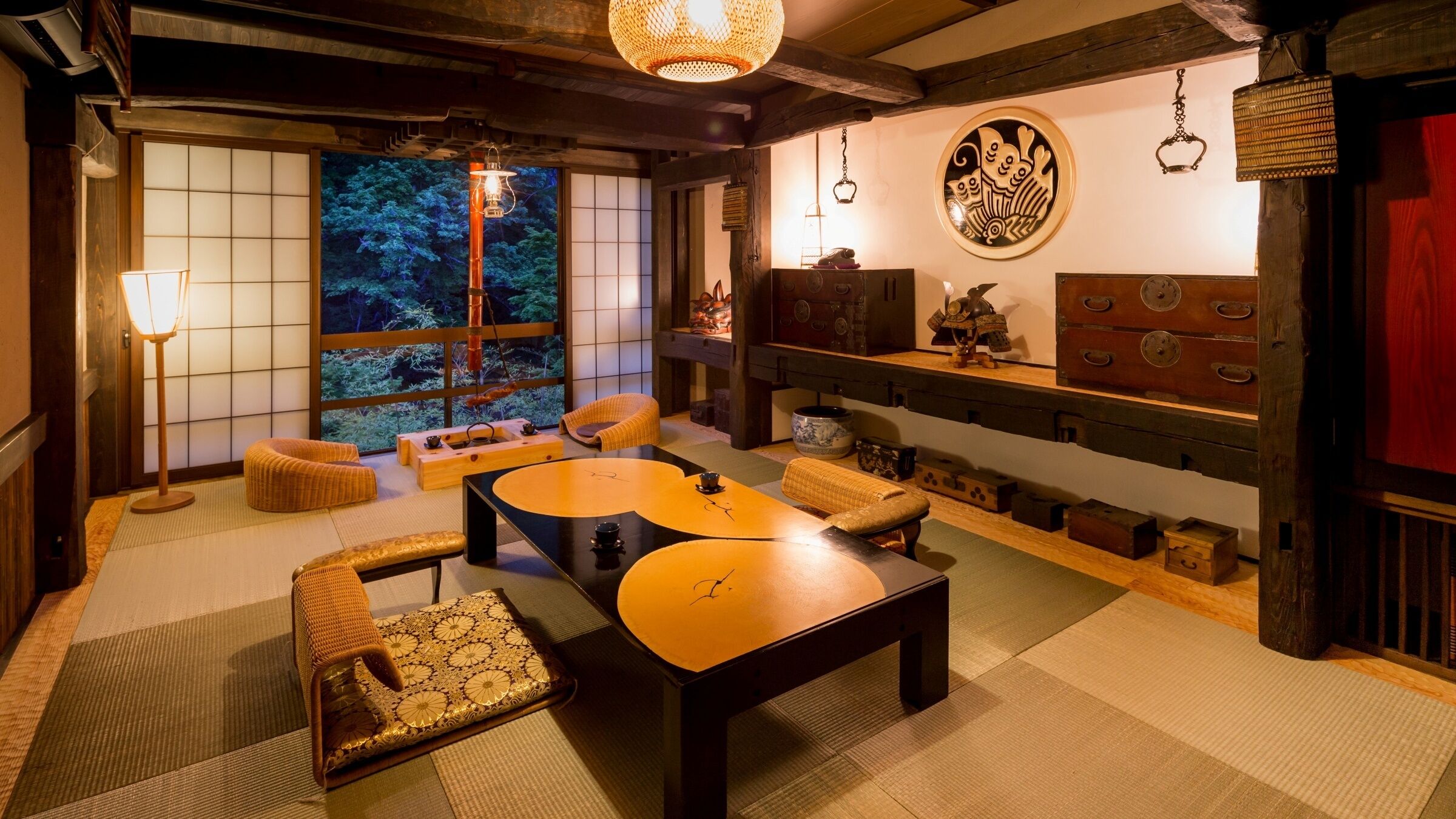 A traditional Japanese room with tatami flooring, low tables, and a view of nature through shoji screens.