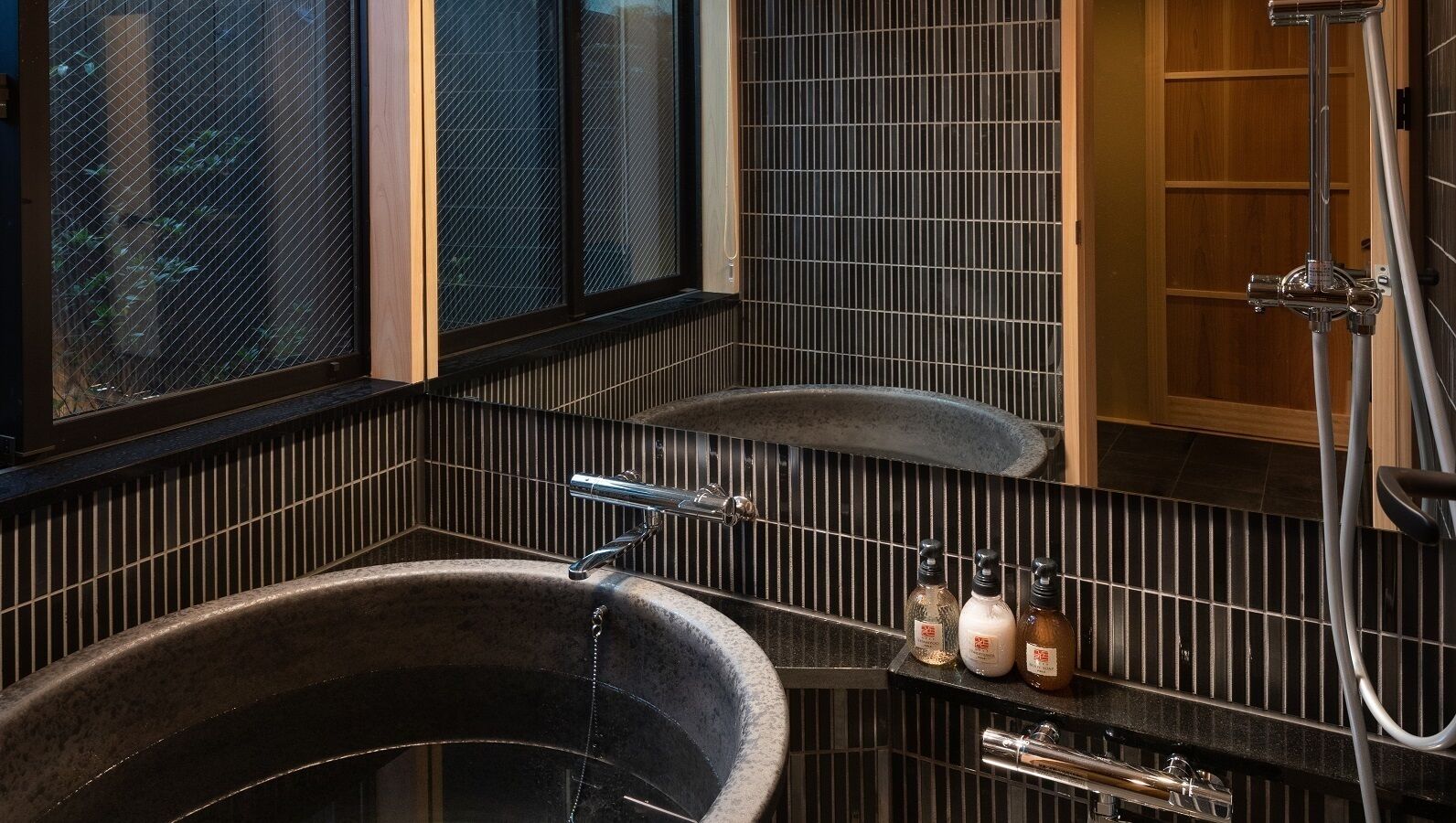 A bathroom with a large bathtub, a separate sink, and a shower.