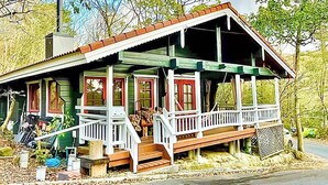 A rustic cabin with a porch, a chimney, and a small deck area. - Asobi No Cottage Hatsukaichi (Hatsukaichi)