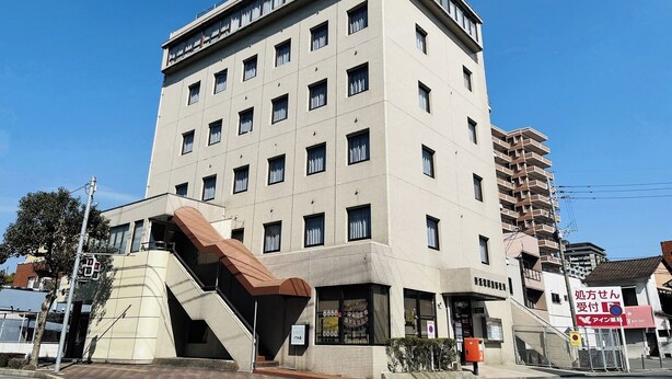 A multi-story building with a flat facade, multiple windows, and a visible entrance. - Business Hotel Century (Iizuka)